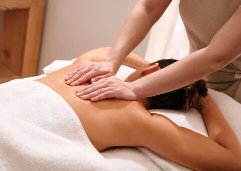 therapist massaging woman's back