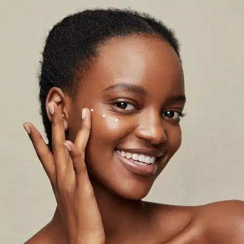 Woman applying an eye cream to her under eye area